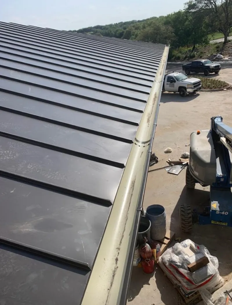 Standing seam panel and gutter detail on a metal roofing jobsite in Bowleys Quarters